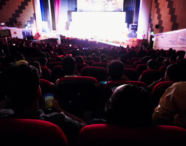 Audience watching a show on a lit stage