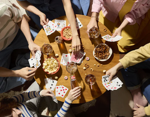 Colleagues playing cards around a table